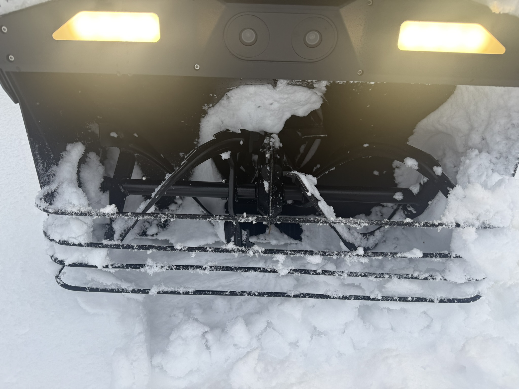 Underside of Yarbo snow blower auger packed with snow